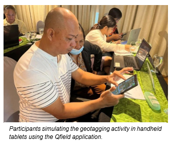 Participants simulating the geotagging activity in handheld tablets using the Qfield application.